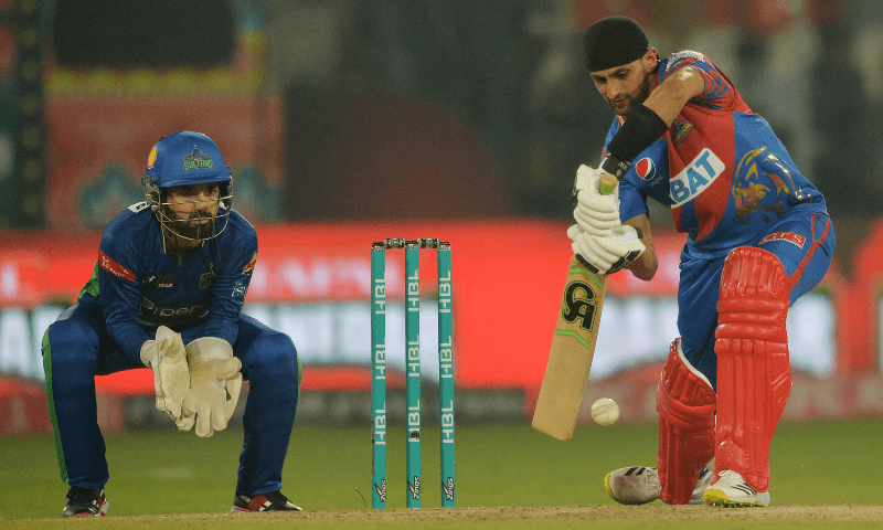 Karachi Kings’ Shoaib Malik (R) plays a shot as Multan Sultans’ captain wicketkeeper Mohammad Rizwan watches during the Pakistan Super League (PSL) T20 cricket match between Karachi Kings and Multan Sultans at the Multan Cricket Stadium in Multan on February 22, 2023. — AFP/File