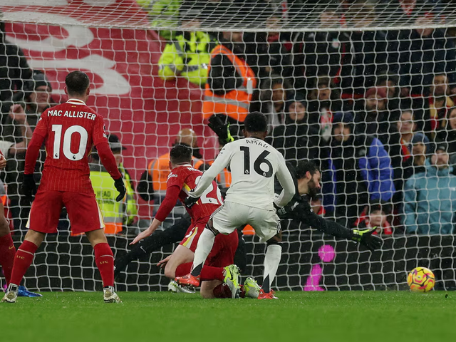 Manchester United's Amad Diallo scores their second goal past Liverpool's Alisson Becker. Photo: Reuters