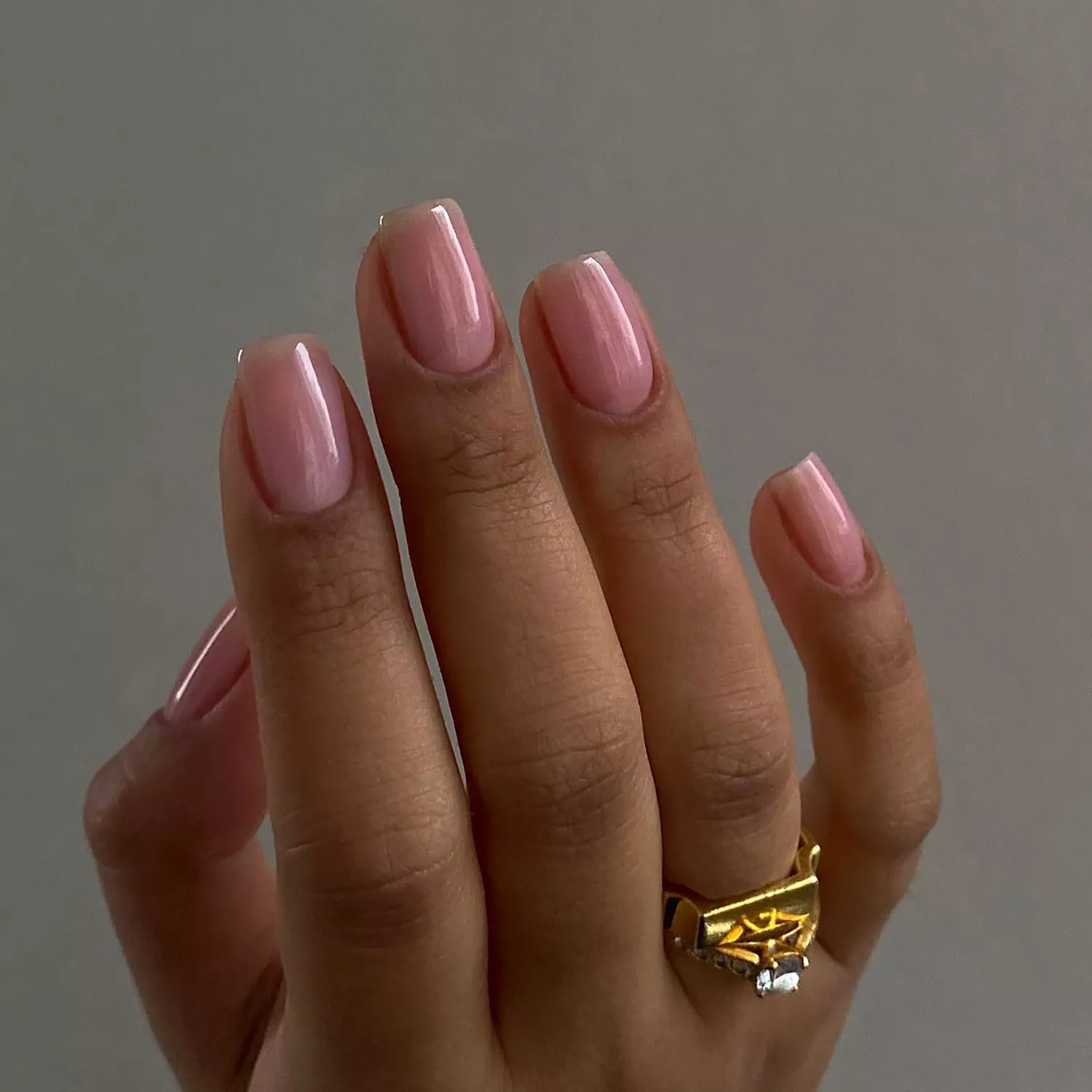 a short, square, glossy strawberry milk manicure