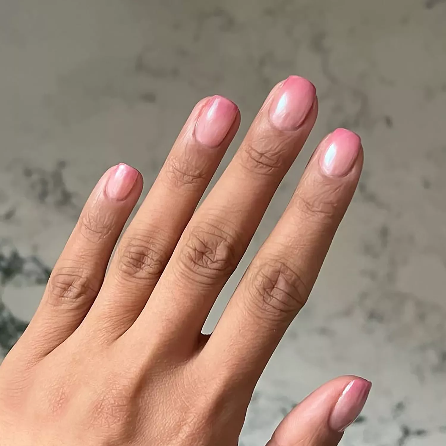 an ombre chrome strawberry milk manicure