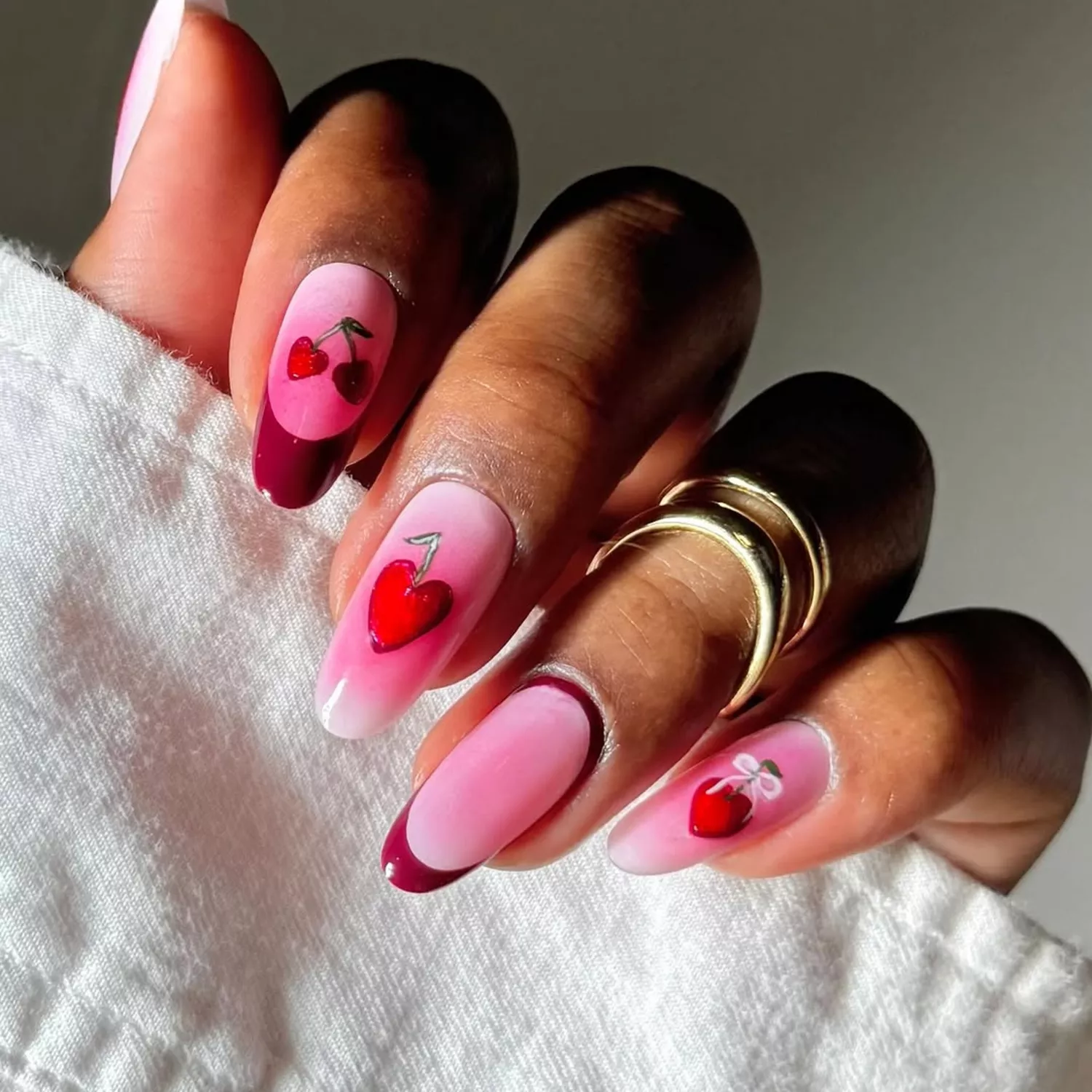 pink aura french manicure with cherry nail art