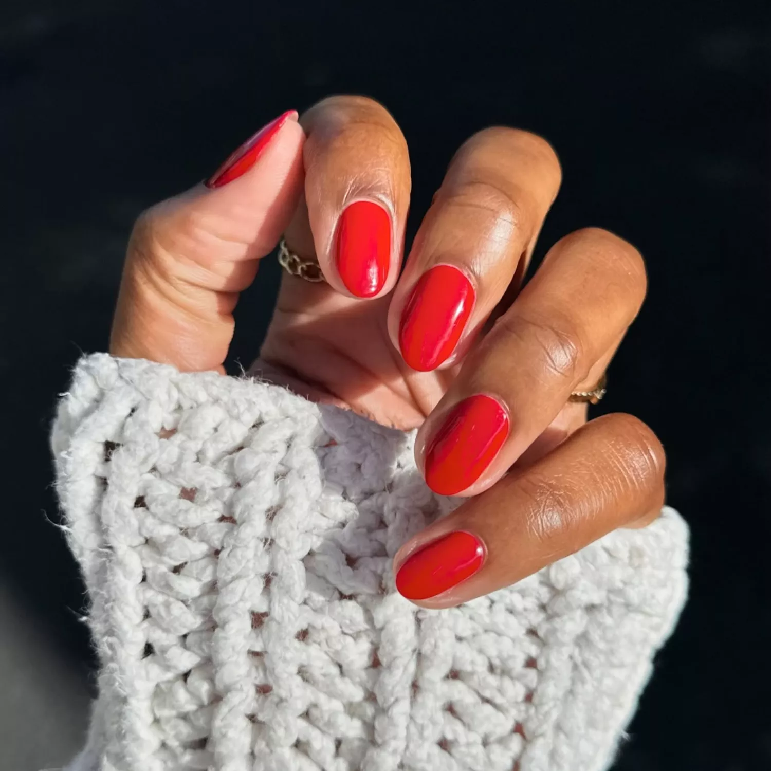 close up of short nail manicure with candy apple red polish