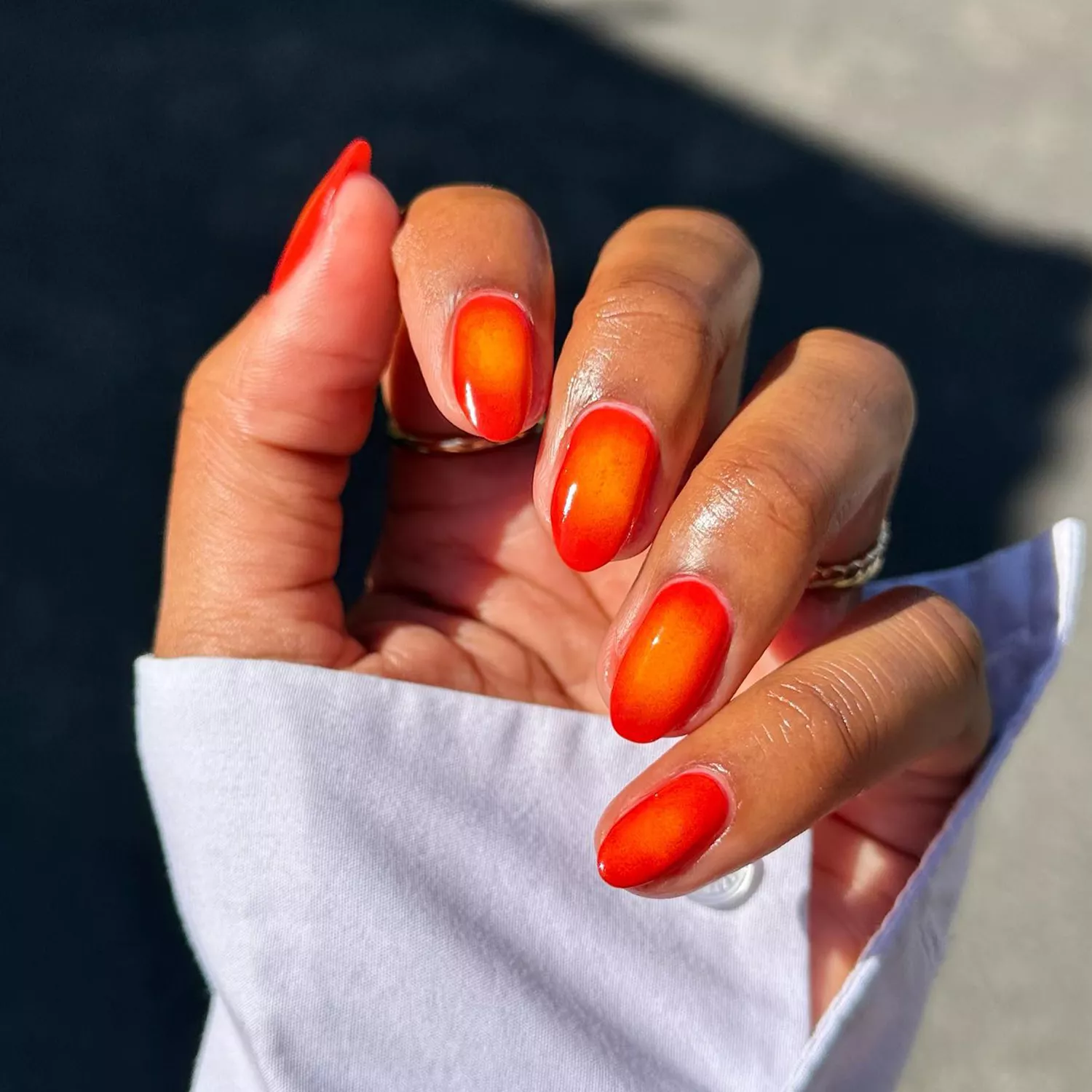 Red and orange aura design on short round nails