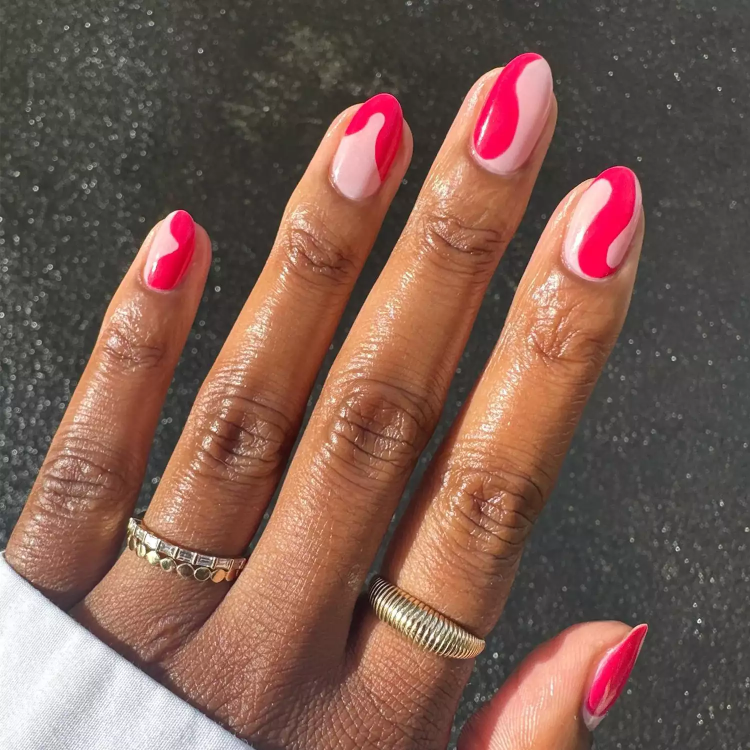 Bright pink swirl accents on short round nails