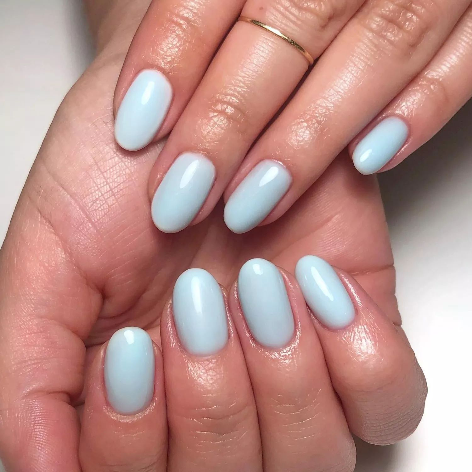 close up of short nail manicure with light blue polish