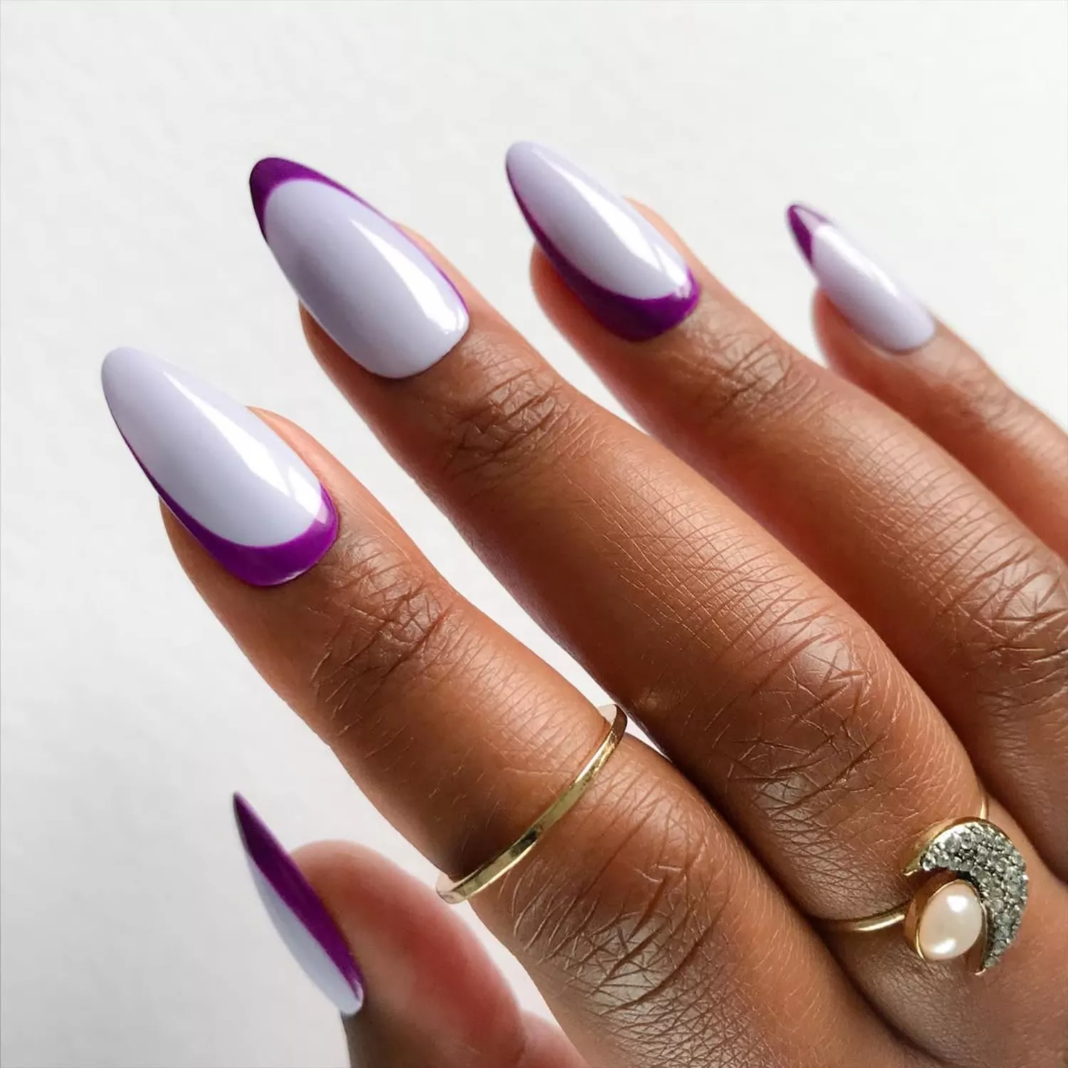 Manicure with lavender base and dark purple swoop design