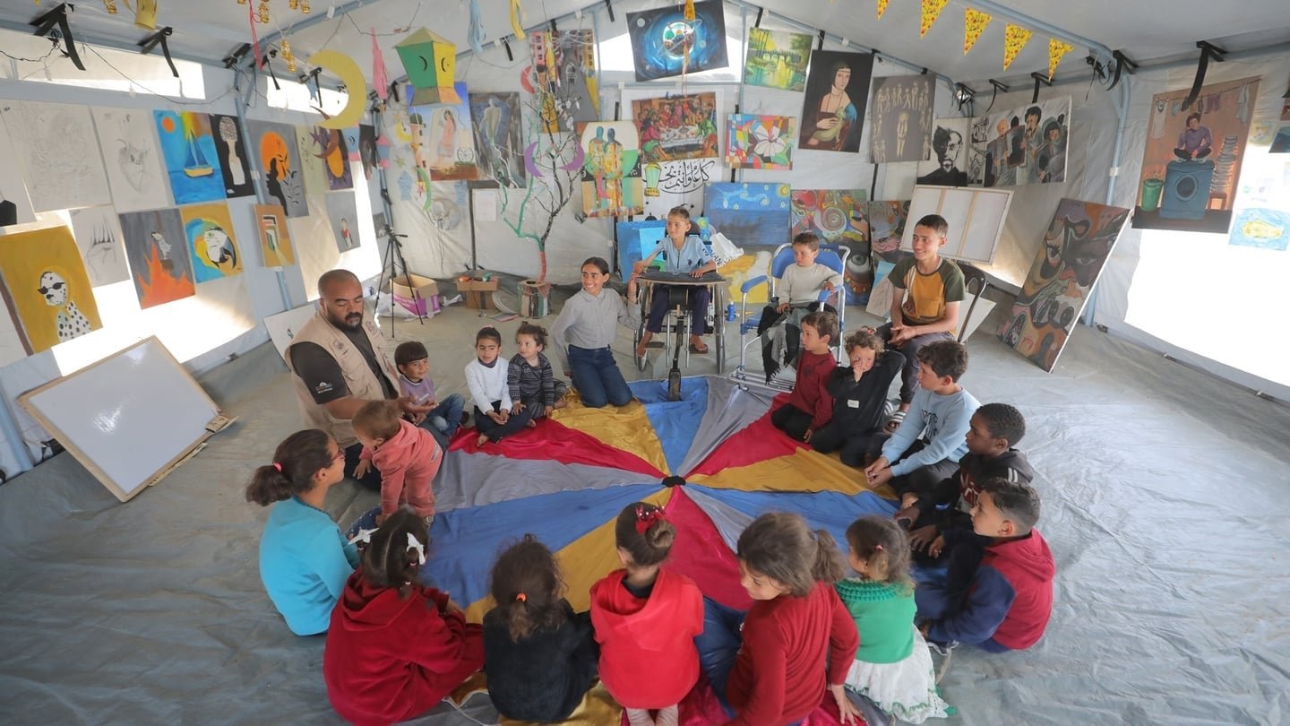 Colourful paintings hang from the plastic tent walls of a makeshift art studio in Zawayda. PHOTO:AFP
