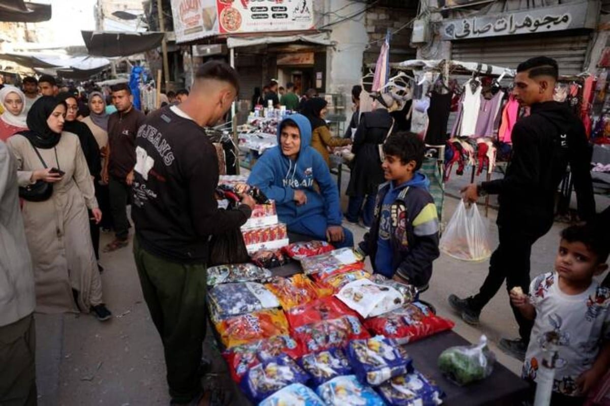 Palestinians shop on the eve of Eid Al-Adha in Khan Younis southern of Gaza Strip on May 26, 2026. PHOTO: AFP